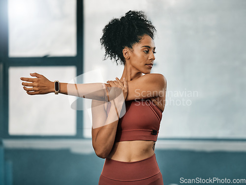 Image of Fitness, black woman or girl in gym stretching arms to warm up body or relax muscles for workout exercise. Wellness, focus or healthy sports athlete ready to start training or exercising in Atlanta