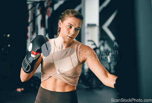 Image of Fitness, sports and boxing with woman in gym for training, workout and mma challenge. Performance, energy and power with girl boxer and focus for fight, wellness and exercise in martial arts class