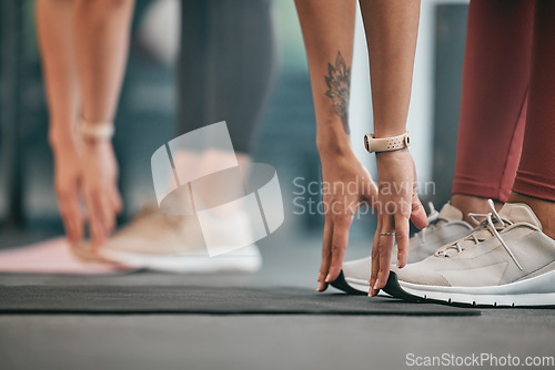 Image of Fitness, hands or friends stretching legs at gym to warm up body or relax muscles for workout exercise. Women, focus or healthy sports people training together for support, inspiration or motivation