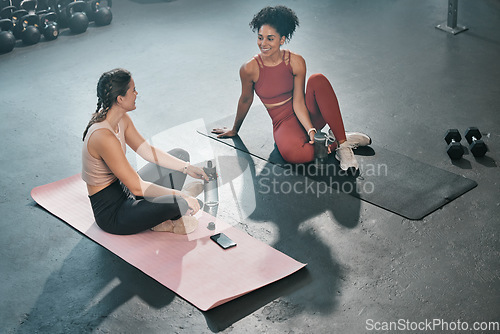 Image of Fitness, relax or friends in gym talking, conversation or speaking of body goals after workout exercises. Girls, gossip or healthy sports women resting or relaxing on break after training together