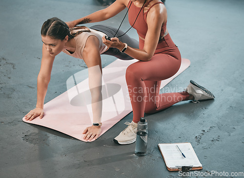 Image of Personal trainer, plank and stopwatch with a black woman coaching a client in a gym for fitness from above. Health, exercise or workout and a female athlete training with her coach recording time