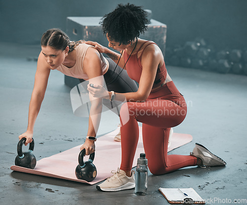 Image of Personal trainer, stopwatch and fitness with a woman athlete lifting weights during a plank in the gym for a workout. Coach, time and exercise with a female training using kettle bell equipment