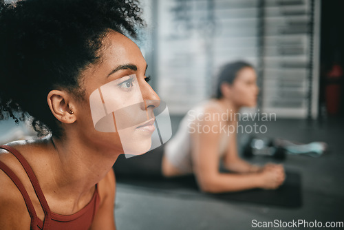 Image of Black woman, gym focus and plank exercise of a person on the floor busy with workout and wellness. Sports, ground training and strength performance challenge of girl friends at a fitness health club