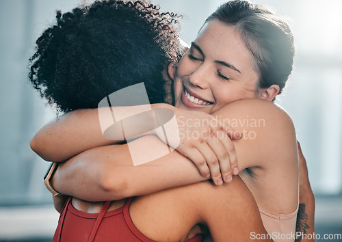 Image of Fitness, women or friends hug at gym for support after workout, sports exercise or training. Happy girls, embrace or healthy sports people smile while hugging after exercising together for motivation