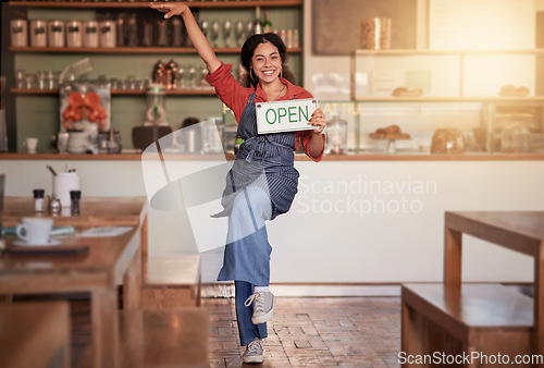 Image of Cafe, woman and open sign in small business, startup and excited while celebrating success with dance. Black woman, coffee shop and business owner hold message, placard or advertising welcome board