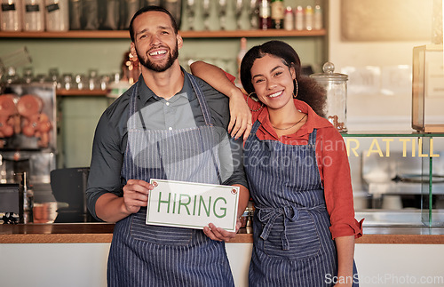 Image of Small business, portrait or couple with a hiring sign for job vacancy offer at a cafe or coffee shop. Recruitment, marketing or happy entrepreneurs smile standing with an onboarding message in store