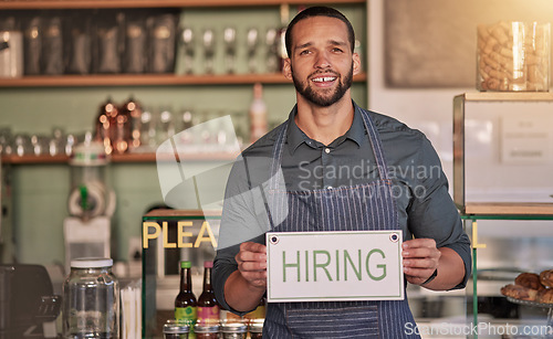 Image of Small business, man or business owner with a hiring sign for job vacancy offer in cafe or coffee shop. Boss, marketing or happy entrepreneur smiles with an onborading recruitment message in store