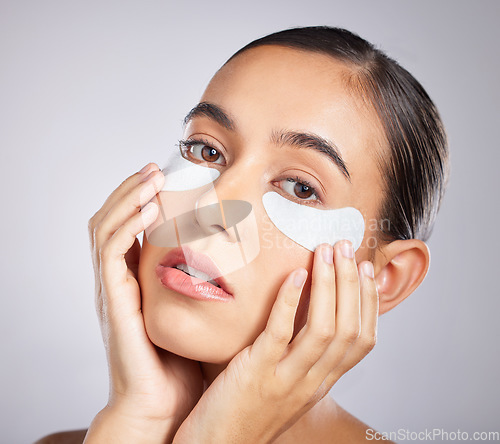 Image of Beauty, eye patch and face of woman with skincare product for self care, anti aging or facial wellness. Healthcare, spa salon and portrait of aesthetic girl with makeup cosmetics on studio background