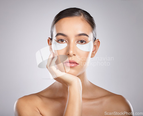 Image of Beauty, eye patch and portrait of woman with skincare product for self care, anti aging and wellness. Facial healthcare, spa salon and aesthetic model face with makeup cosmetics on studio background