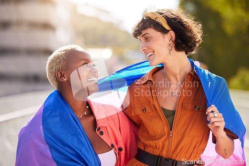 Image of Friends, city and pride flag in street with support, smile and solidarity with human rights for lgbt people. Women, non-binary march, parade and diversity in urban metro for lgbtq, equality and peace