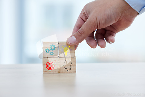 Image of Business, hand and wooden block with icon for idea, strategy and target for building startup company. Growth, development and goals, blocks for planning process and future success at small business.