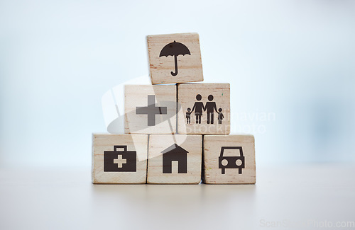 Image of Building blocks, pyramid and life insurance for medical, car loan or home on background mockup, table or desk mock up. Zoom, wooden and cubes for house risk management, security and future protection