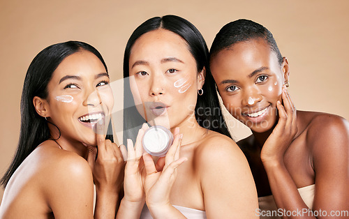 Image of Skincare, portrait and diversity by friends with face cream product in studio for wellness on brown background. Face, model and lotion by women for beauty, different and facial, skin and joy isolated