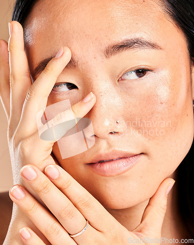 Image of Asian woman, face and hands thinking for beauty wellness, skincare dermatology cosmetics skin glow in studio. Model, facial treatment and relax natural self care vision or cosmetology healthcare