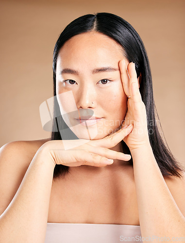 Image of Asian woman, beauty portrait and hands for skincare wellness, dermatology cosmetics and natural skin glow in studio. Model, face treatment and relax self care vision or cosmetology facial healthcare