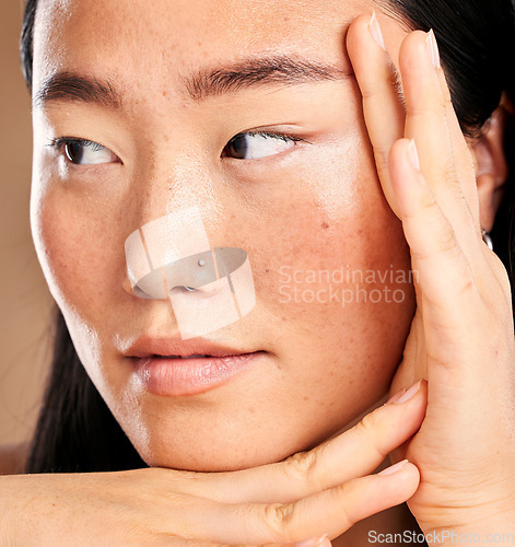 Image of Closeup face, hand frame and asian woman in studio with skincare, skin glow or healthy cosmetics. Happy japanese model, cosmetic beauty and aesthetic with self care health, wellness or natural makeup