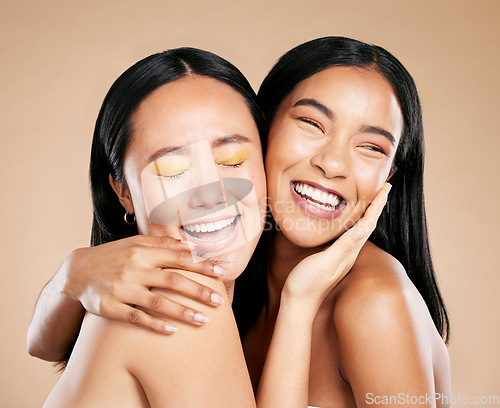 Image of Beauty, love and diversity with model woman friends in studio on a beige background for natural skincare. Makeup, health and wellness with an attractive young female holding the head of her friend