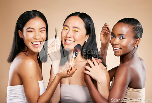 Image of Diversity, smile and woman with makeup tools products for facial skincare, cosmetics dermatology and skin wellness. Interracial models, happy face portrait and luxury product satisfaction in studio