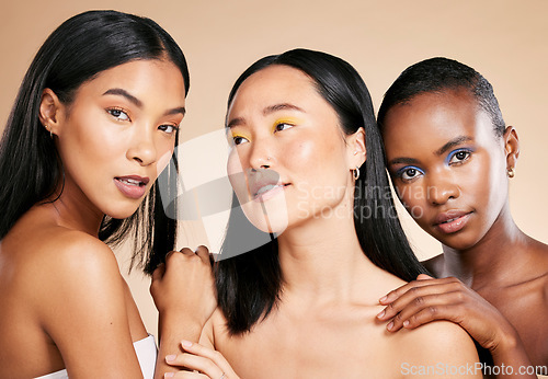 Image of Diversity, skincare and women with cosmetics, dermatology and wellness on brown studio background. Makeup, multiracial and ladies with healthy, smooth and clear skin for confidence and wellness