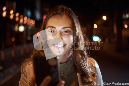 Image of Student, face or phone in city night, road or street on social media, taxi call or cab search in Dubai location. Smile, happy woman or tourist person on mobile communication technology in dark travel