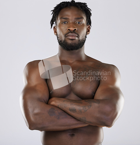 Image of Muscle, fitness and sexy black man portrait in studio for strong body and power. Health and wellness of a confident male bodybuilder person with arms crossed after exercise, workout and training