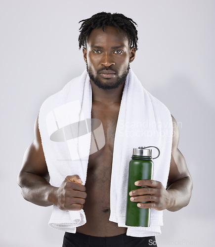 Image of Black man, exercise and portrait with towel and water bottle for sports training in studio. Health and wellness of a sexy male bodybuilder model with ready for fitness workout, goals and strong body