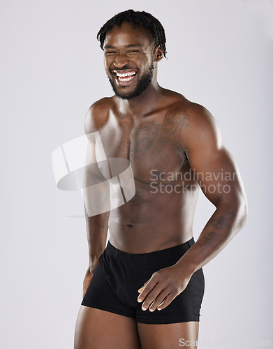 Image of Black man, fitness and happy body portrait of sports person in studio for strong muscle and underwear. Health and wellness of sexy male bodybuilder laughing after exercise, workout and training