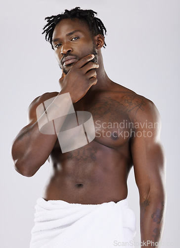Image of Skin, black man in towel and muscle in portrait, shower with hygiene and beauty isolated on studio background. Abs, fitness and facial wellness, skincare glow and body care with natural cosmetics
