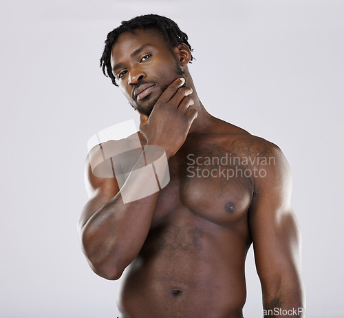 Image of Thinking, portrait and black man in studio for wellness, grooming and hygiene on grey background. Muscular, man and beauty routine on mockup, relax and skincare treatment on shirtless model isolated