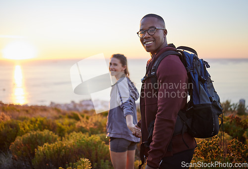 Image of Portrait, wellness and hiking interracial couple exercise in sunset on a mountain as a morning workout in nature. Fitness, man and woman in a relationship training for health and wellness together