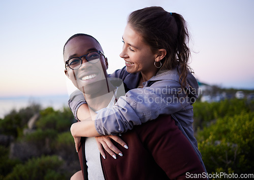 Image of Love, nature and interracial couple piggyback on mountain adventure for holiday, vacation and hiking on weekend. Travel, dating and happy man carry woman enjoying calm, outdoor freedom and peace