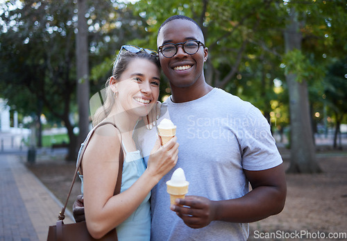 Image of Eating, interracial and portrait of couple with ice cream in a park on a date, anniversary or walk. Love, smile and man and woman with a sweet dessert while walking in nature with romantic affection