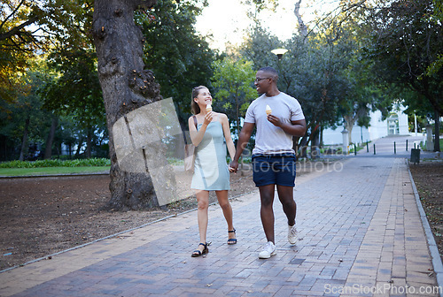 Image of Couple on date in park, ice cream and holding hands outdoor, love and commitment in relationship. Romance in nature, black man and woman eat dessert for quality time together, trust and interracial