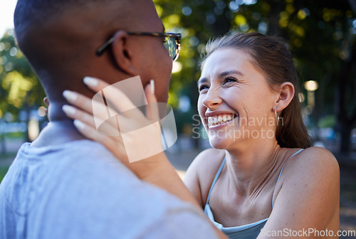 Image of Love, happy or couple of friends in a park bonding on a romantic date in nature in an interracial relationship. Embrace, funny black man and young woman enjoying quality time on a holiday vacation