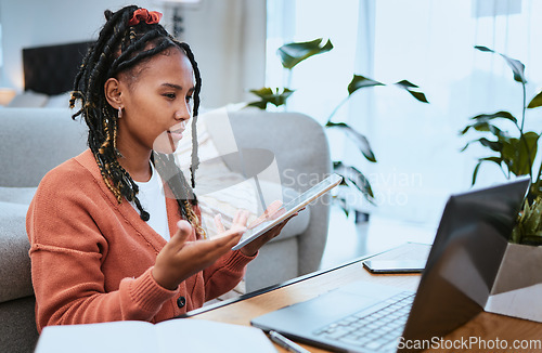 Image of Black woman, laptop or student with tablet for education in living room for elearning, research or planning college scholarship. Confused girl on video call for internet, university or website search