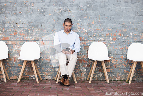 Image of Phone, recruitment or startup man in digital agency waiting room on tech for HR or hiring team. Business man, research or employee on smartphone job interview for cyber, programmer or hacker meeting