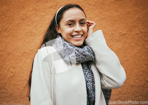 Image of Happy woman, portrait or hair tuck behind ear by city wall, mockup background or brown mock up in Portugal. Smile, fashion or model in trendy, cool or warm style clothes on building copyspace brand