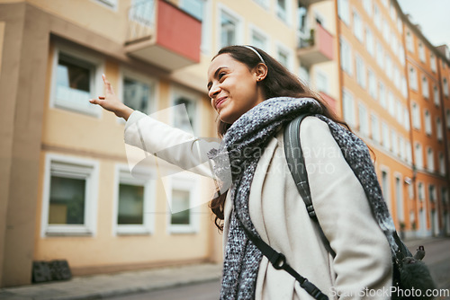 Image of Happy woman, travel and hailing taxi in city, street and road in transportation, traveling and urban commute. Smile, tourist and fashion student stopping cab, lift or sightseeing bus in town location