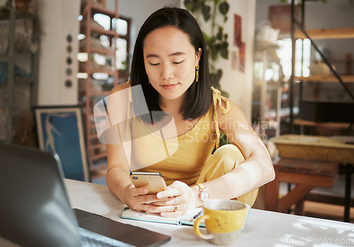 Image of Asian woman, cafe and smartphone for connection, remote work and lady with online research, chatting and comfortable. Female, creative and freelancer in coffee shop, relax and texting for project