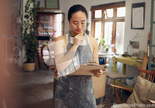 Image of Woman, thinking or clipboard in pottery studio, ceramic small business or Asian art workshop on class schedule. Mud, craft or designer worker with clay vision, ideas or innovation on paper documents