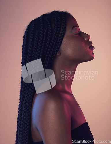 Image of Peace, calm and black woman with braids in a studio with a makeup, cosmetic and face routine. Sensual, cosmetics and African female model with a relaxing positive mindset isolated by pink background.