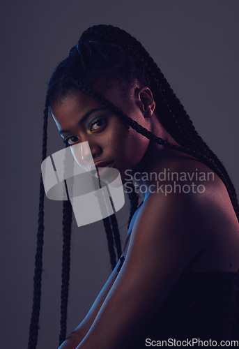 Image of Beauty, makeup and portrait of a black woman in a studio with braids, cosmetic and natural face. Cosmetics, beautiful and young African female model with a facial treatment by a dark gray background.