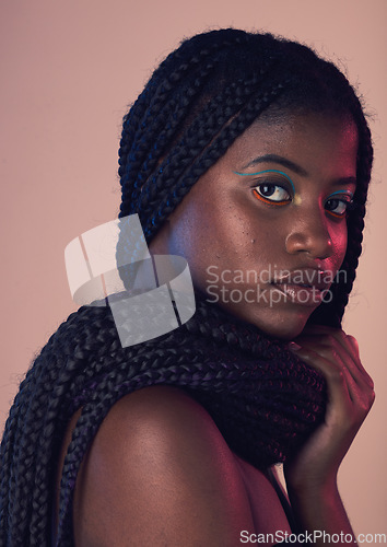 Image of Portrait, hair and makeup with a model black woman in studio on a wall background for natural haircare. Face, beauty and braids with an attractive young female posing to promote keratin treatment