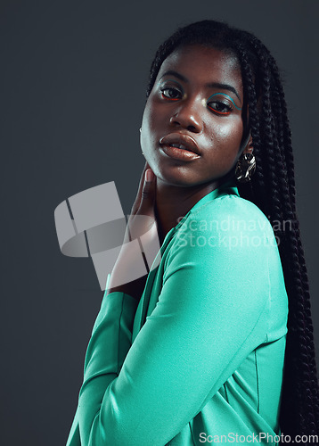 Image of Fashion, stylish and portrait of a confident black woman isolated on a black background in studio. Fashionable, attractive and face of an African model with confidence and empowerment on a backdrop