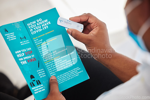 Image of Black man, hands and covid test with brochure for information, insurance or sample at hospital. Hand of African American patient holding rapid test or pamphlet for healthcare instruction or diagnosis