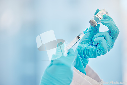 Image of Covid vaccine, injection and hands of a doctor with medicine, virus cure and medication at clinic. Healthcare, corona and medical worker extracting liquid from a syringe for a hospital vaccination