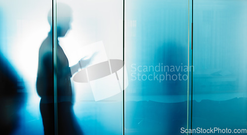 Image of Glass wall, email and businessman reading on a phone for contact, communication and work. Silhouette, social media and employee typing on a mobile chat with news, information and app for work