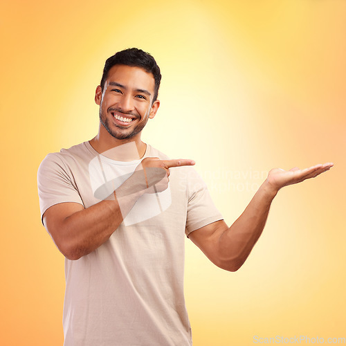 Image of Portrait, pointing and man with product placement in studio isolated on yellow background. Mockup, branding and happy male with gesture for copy space, mock up or advertising, marketing or promotion