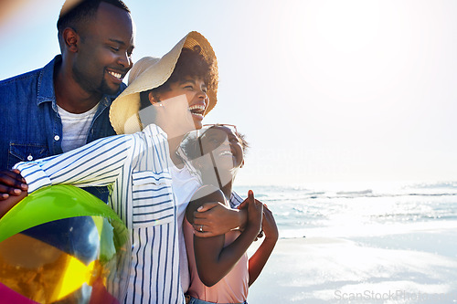 Image of Black family, children or beach with a mother, father and daughter carrying a ball, walking on sand by the sea. Love, nature and ocean with a man, woman and girl child playing on the coast in summer