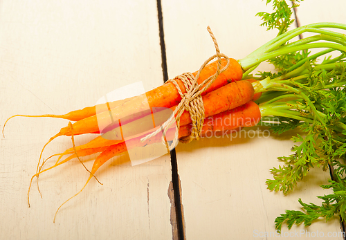 Image of baby carrots bunch tied with rope